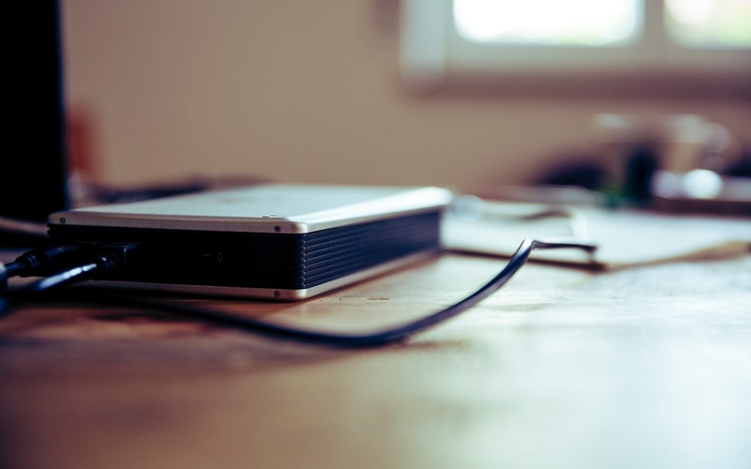 gray and black corded device on table